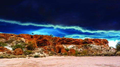 A visibly cloudy storm front dramatically approaching the shoreline